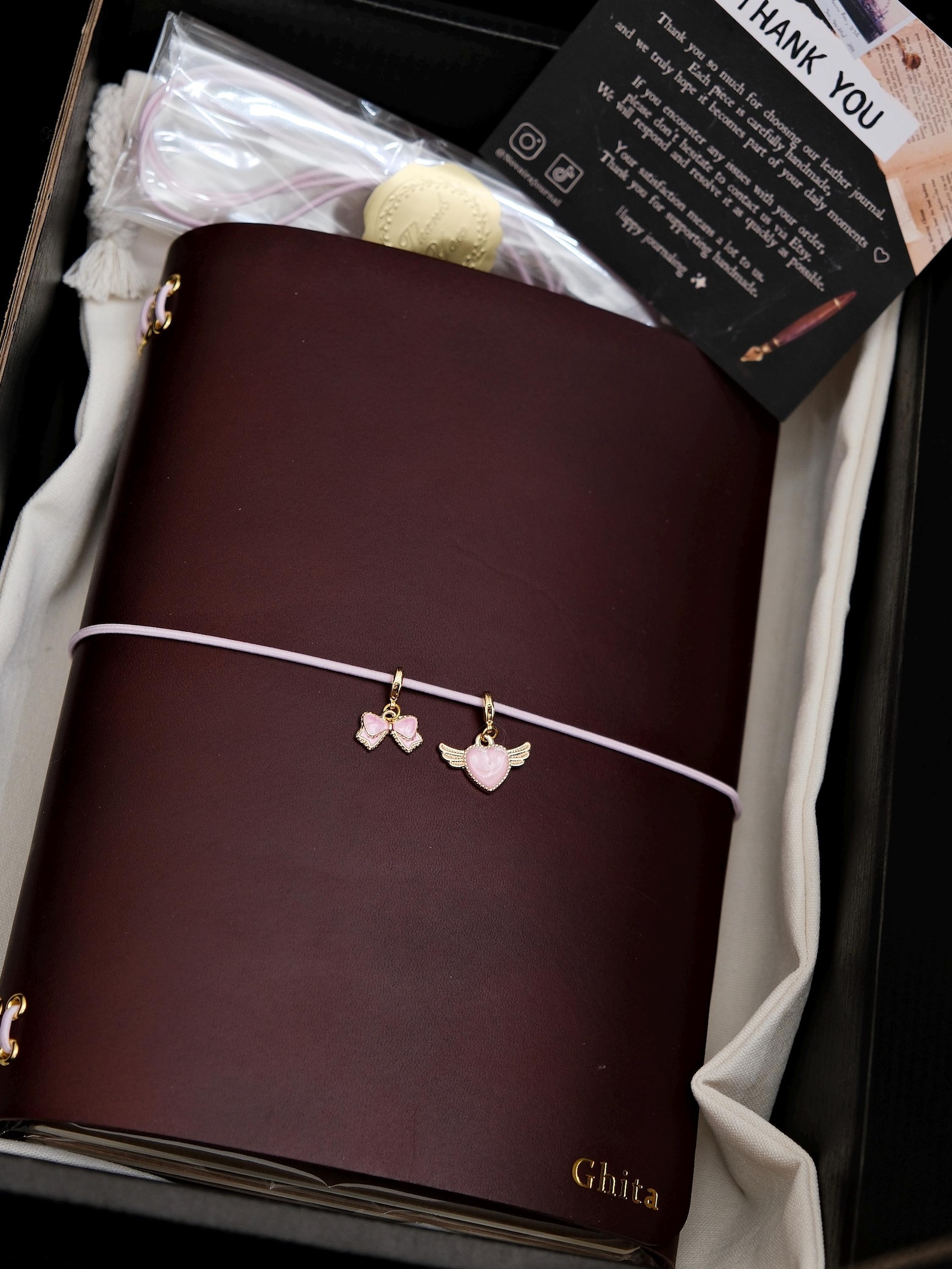 Burgundy leather journal beautifully packaged in gift box with thank you card and decorative charms